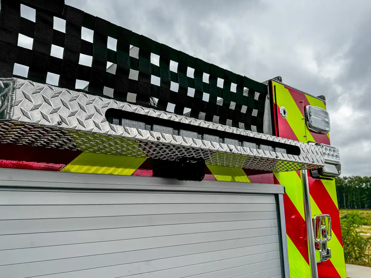 Rear-left taillight and chevron close-up with bumper treadplate.
